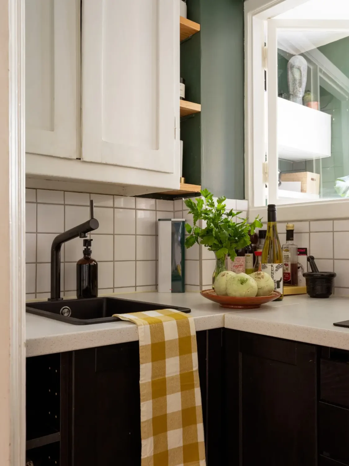 A 1920s Studio Apartment with a Forest Green Sleeping Alcove 17 tiny kitchen black faucet