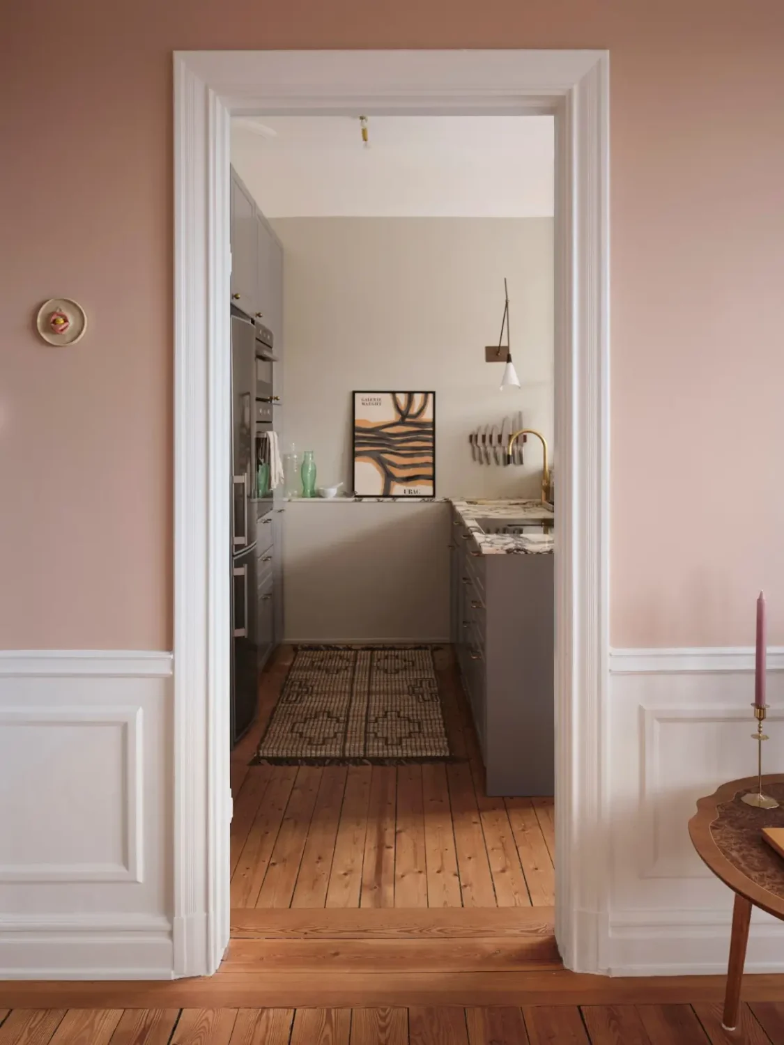 Warm Pink Walls and a Glass Room Divider in a Small Stockholm Apartment 17 view into kitchen