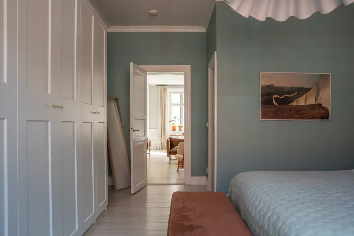 A Light Turn-of-the-Century Apartment with a Blue Kitchen 23 wardrobe wall blue bedroom