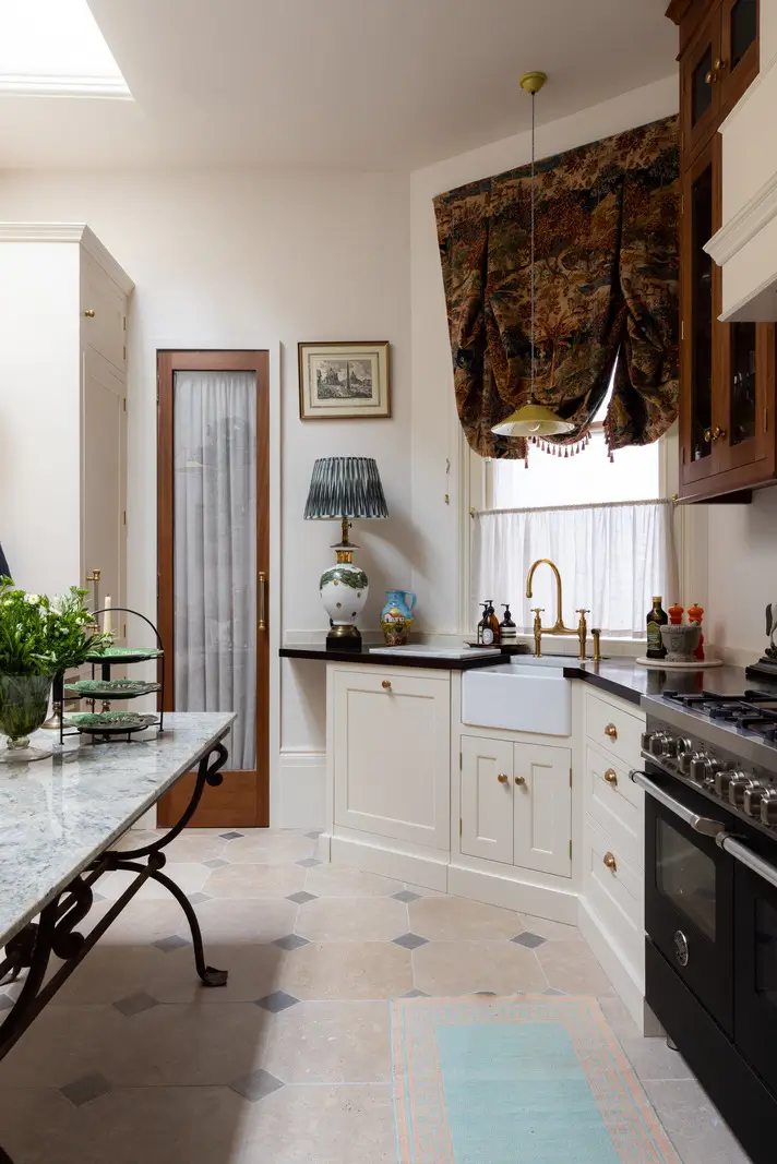 A Mixture of Patterns, Colors, and Materials in a Stunning London Apartment 9 white kitchen cabinets butler sink oak countertop