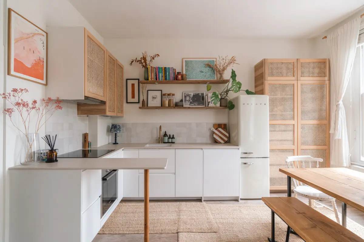 A Bright and Cozy One-Bedroom Apartment in London 6 white kitchen with wooden shelves and cane doors upper cabinets