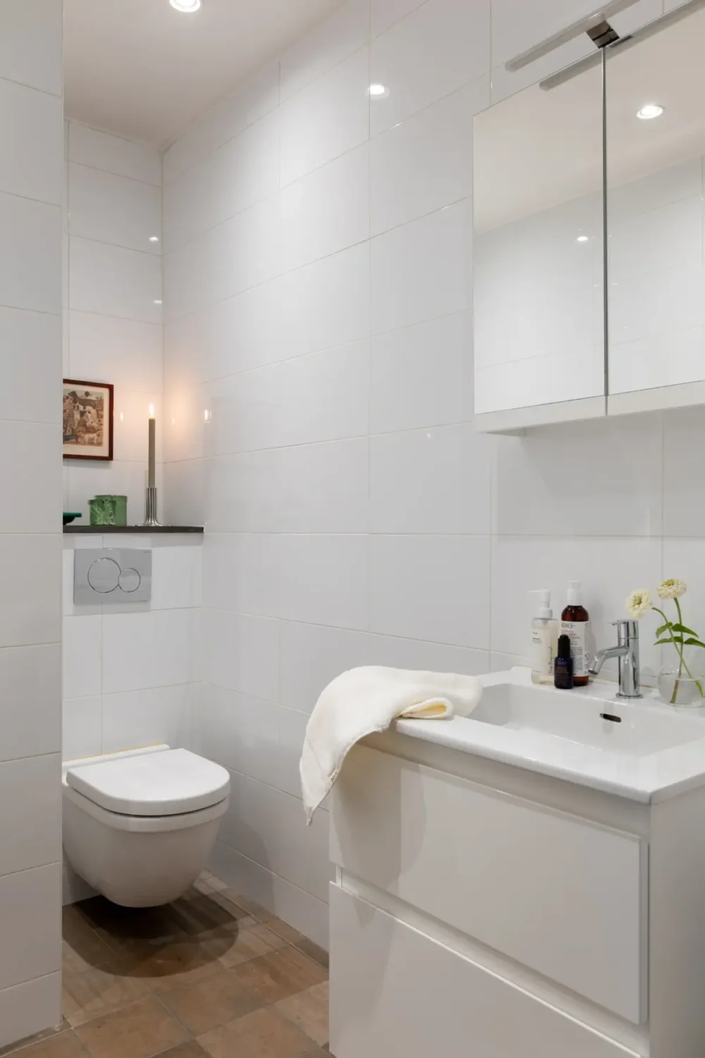 A Warm Color Palette in a Cozy 1920s Apartment in Stockholm 28 white tiled bathroom