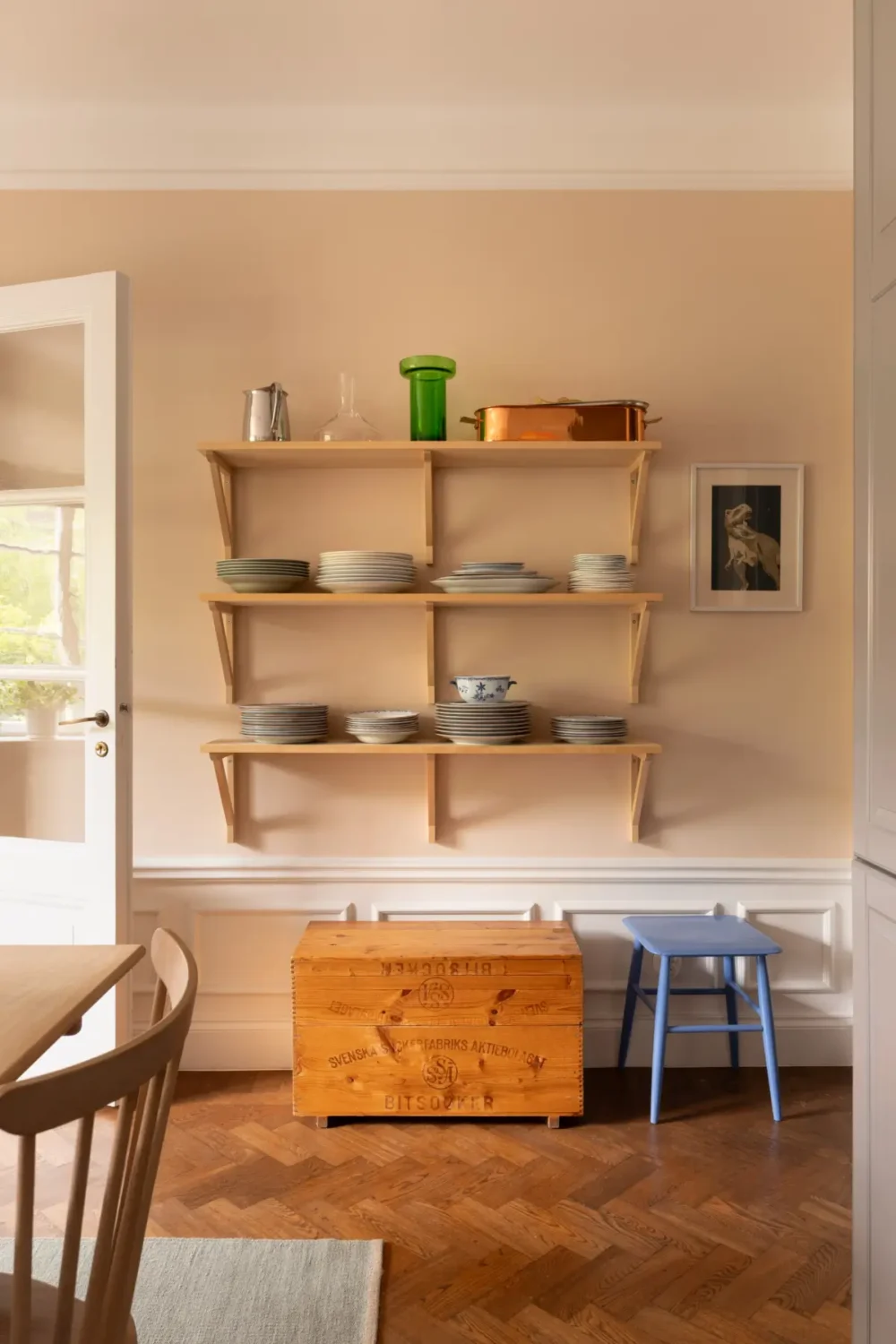 A Warm Color Palette in a Cozy 1920s Apartment in Stockholm 8 wooden kitchen shelves