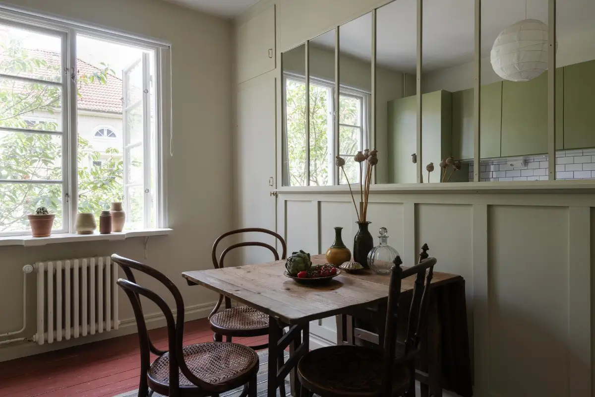 Historic Character and Color in a Swedish Studio Apartment 19 wooden kitchen table mirror wall