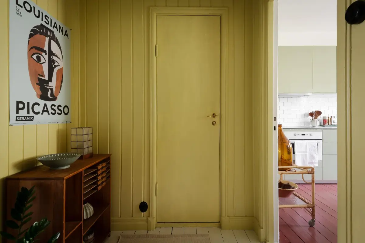 Historic Character and Color in a Swedish Studio Apartment 24 yellow painted paneled hall