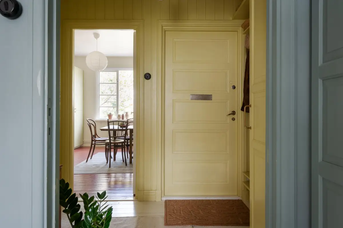 Historic Character and Color in a Swedish Studio Apartment 23 yellow paneled hall