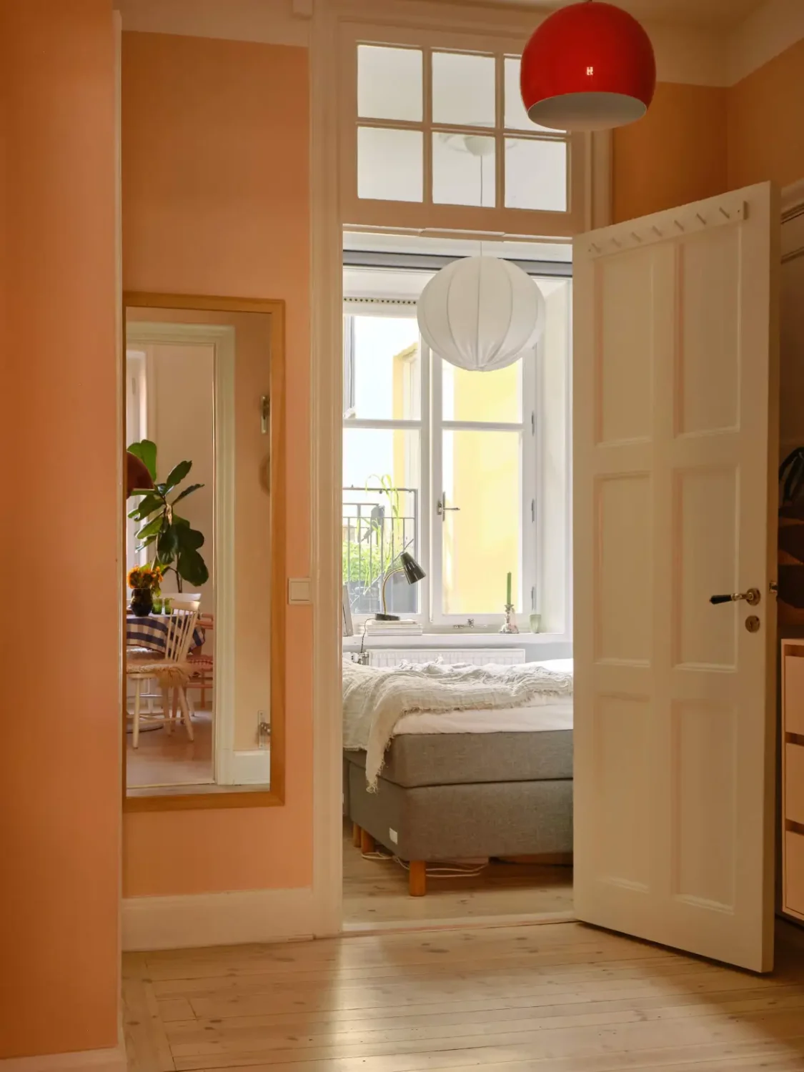 Green and Apricot Rooms in a Charming Stockholm Apartment 19 apricot-colored hall mirror wooden floor nordroom