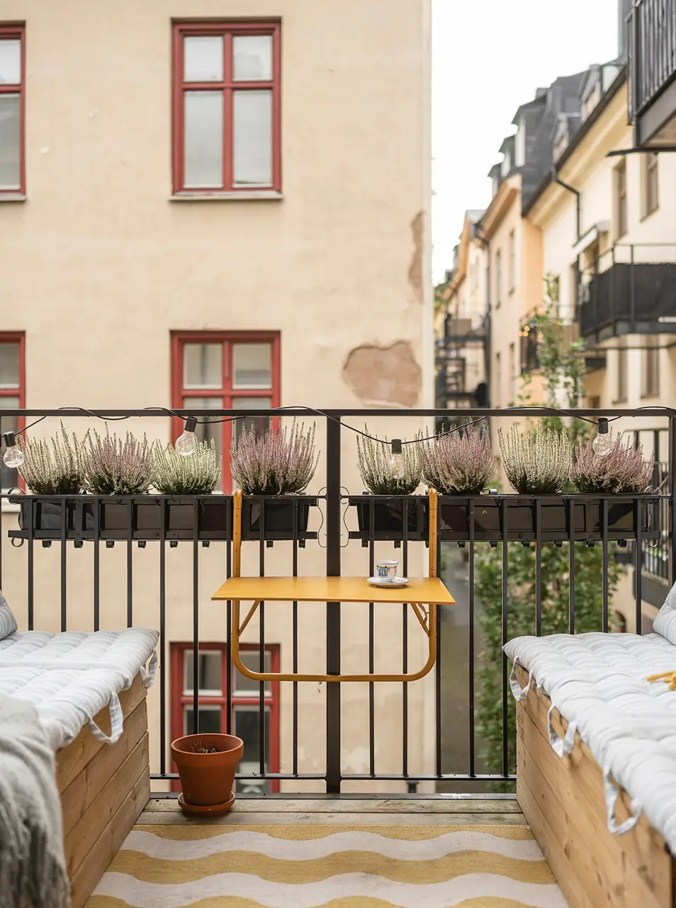 A Stylish Beige Apartment with a Light Blue Kitchen 17 balcony small yellow table