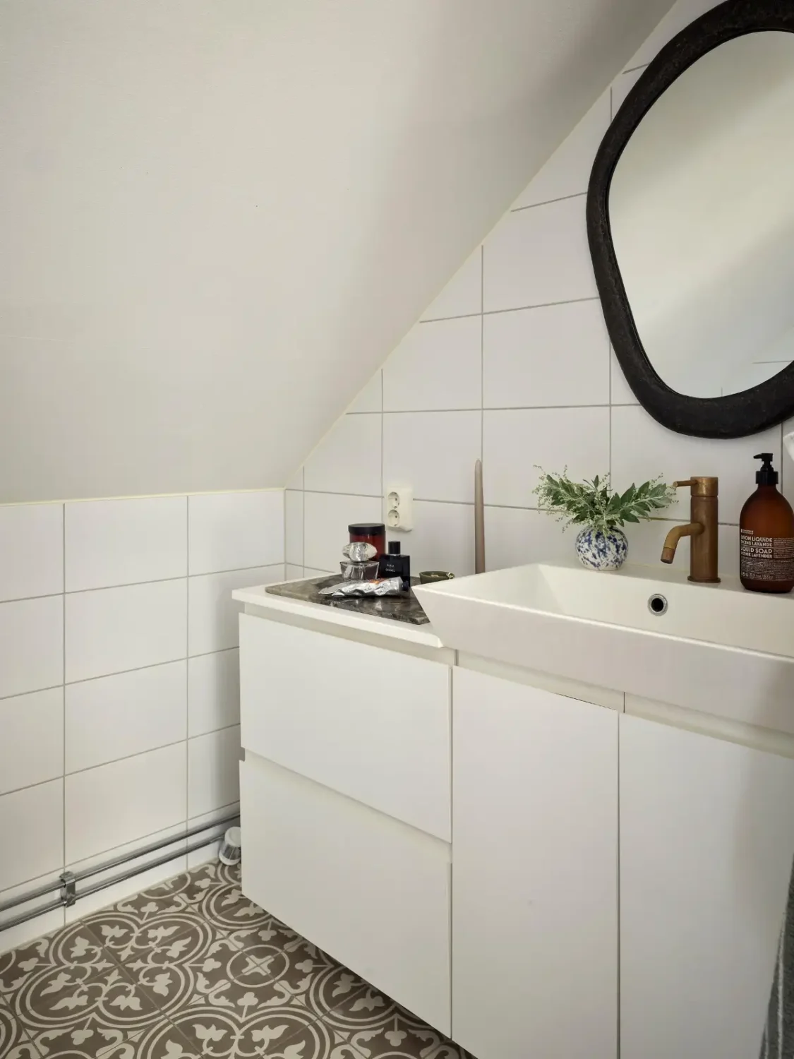 Gray Tones and High Ceilings in a Cozy Swedish Duplex Apartment 21 bathroom slanted ceiling moroccan floor tiles