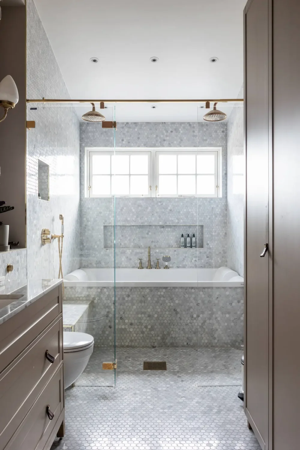 The Top Home Design Trends for 2026: Bold Color, Cozy Corners & Climate-Ready Living 20 bathroom small hexagon marble tiles bath tub double rainfall shower interior trends 2026 nordroom