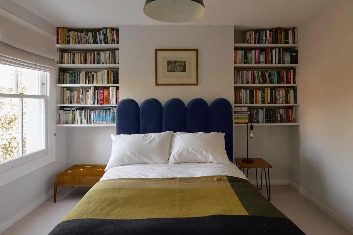 A Beautiful Victorian Townhouse Reimagined for Modern Living 43 bedroom blue velvet headboard bookshelves