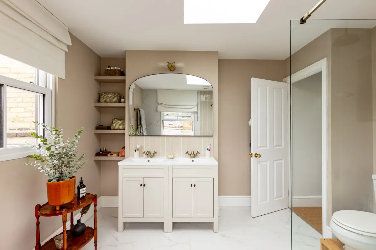 Period Elements and Subtle Color Accents in a Victorian Family Home 17 beige-pink bathroom double sinks marble floor tiles nordroom