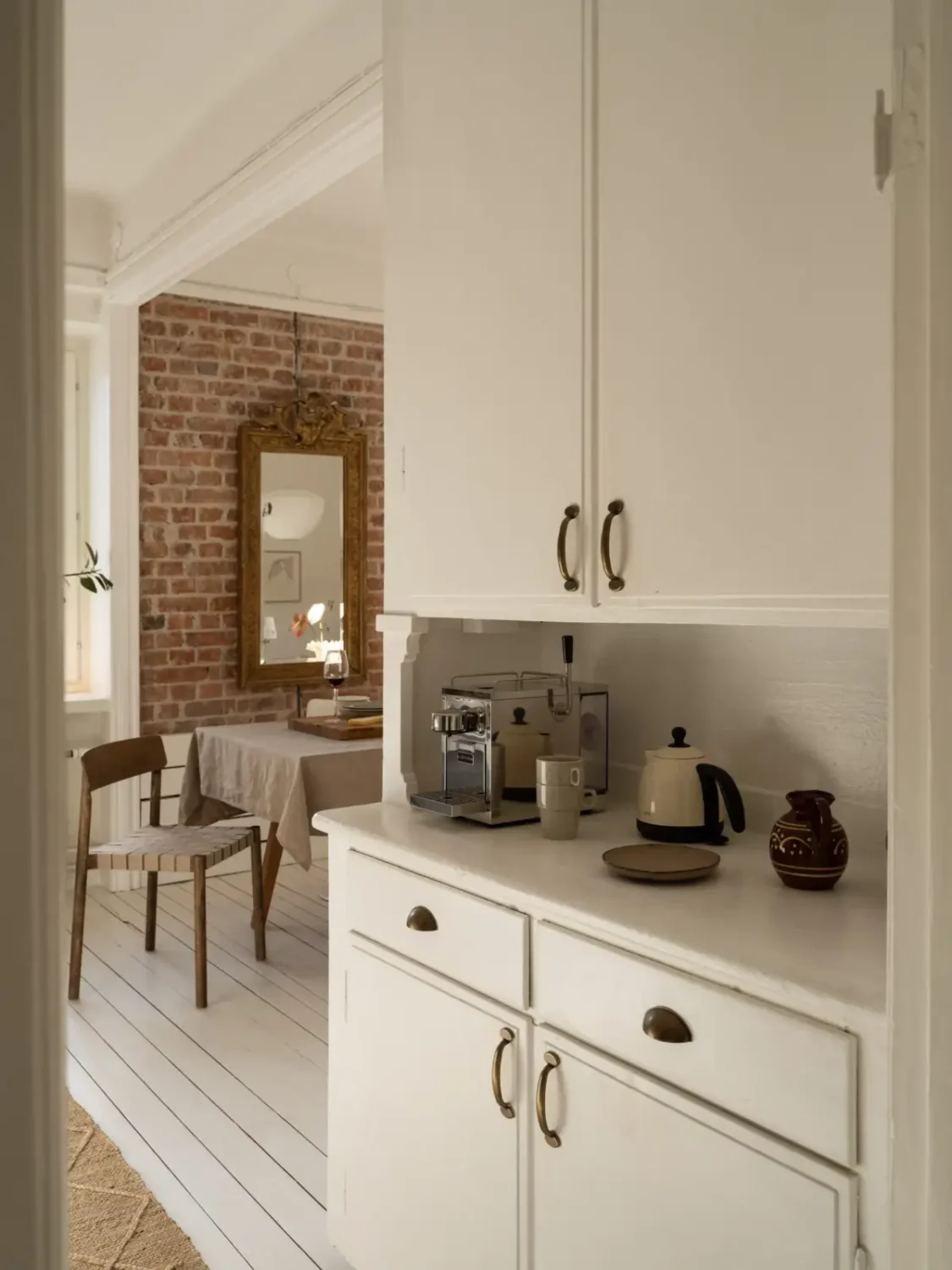 A Fresh 1920s Apartment with White Floorboards and Exposed Brick 11 built-in cabinets
