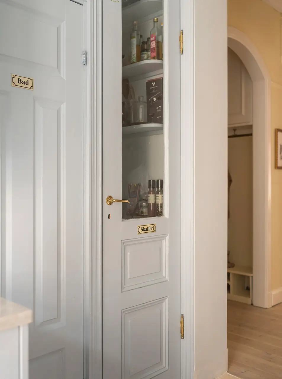 A Stylish Beige Apartment with a Light Blue Kitchen 19 built-in pantry glass door