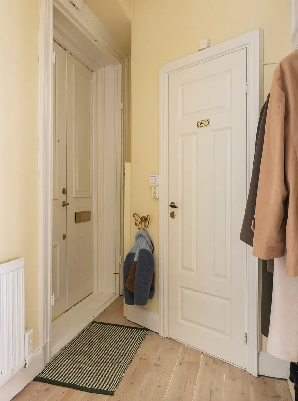 A Stylish Beige Apartment with a Light Blue Kitchen 33 butter yellow entry hall A Stylish Beige Apartment with a Light Blue Kitchen