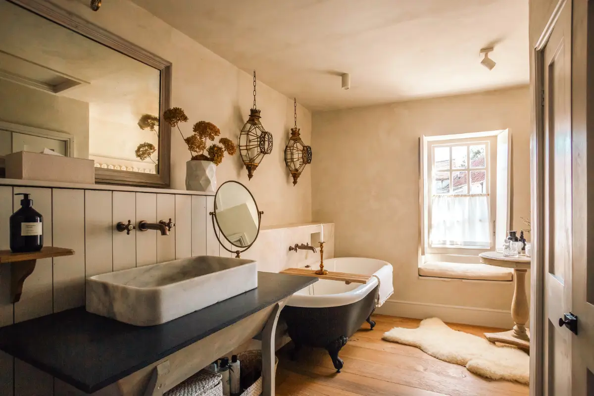 Lime Paint and Cozy Rooms in a Charming English Cottage 24 cottage-bathroom-plaster-walls-freestanding-bath-wooden-floor-window-seat-nordroom