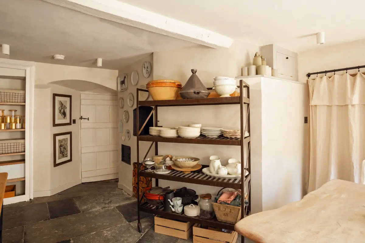 Lime Paint and Cozy Rooms in a Charming English Cottage 7 cottage kitchen stone floor open storage cabinet