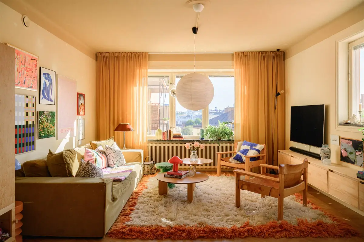 A Colorful Stockholm Family Apartment with Views of the Lake 1 cozy scandinavian living room large shag rug yellow walls nordroom