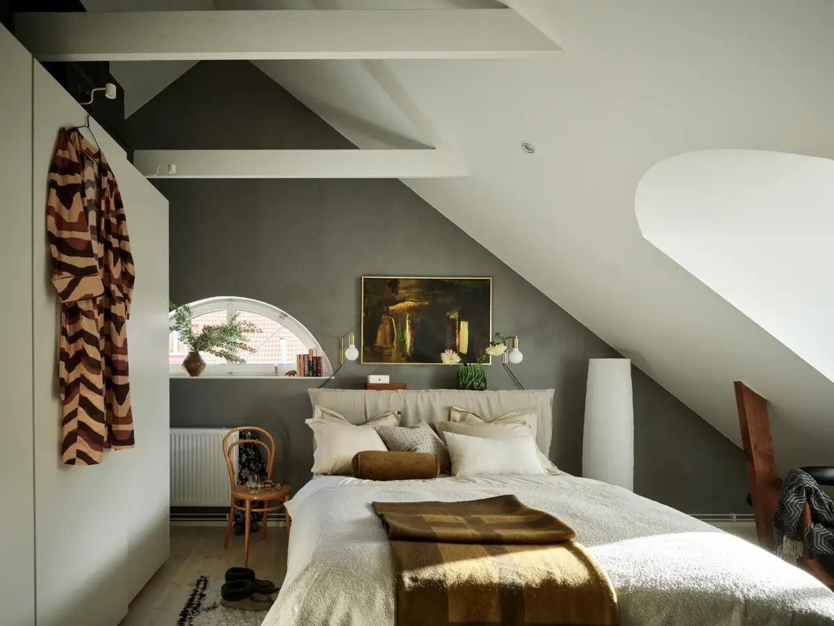 Gray Tones and High Ceilings in a Cozy Swedish Duplex Apartment 12 dark gray wallpaper bedroom pitched ceiling exposed beams white wardrobes