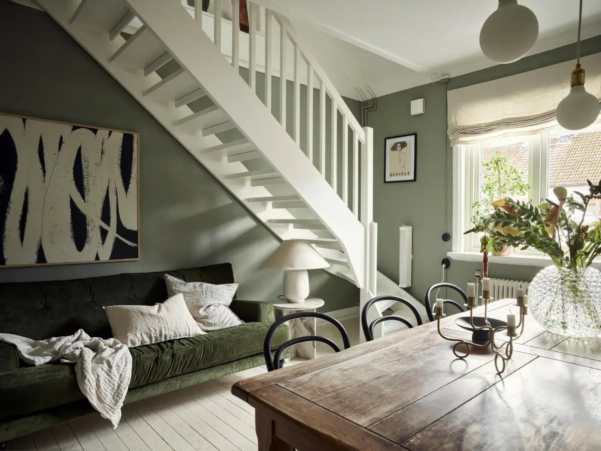Gray Tones and High Ceilings in a Cozy Swedish Duplex Apartment 23 dining room with velvet green sofa