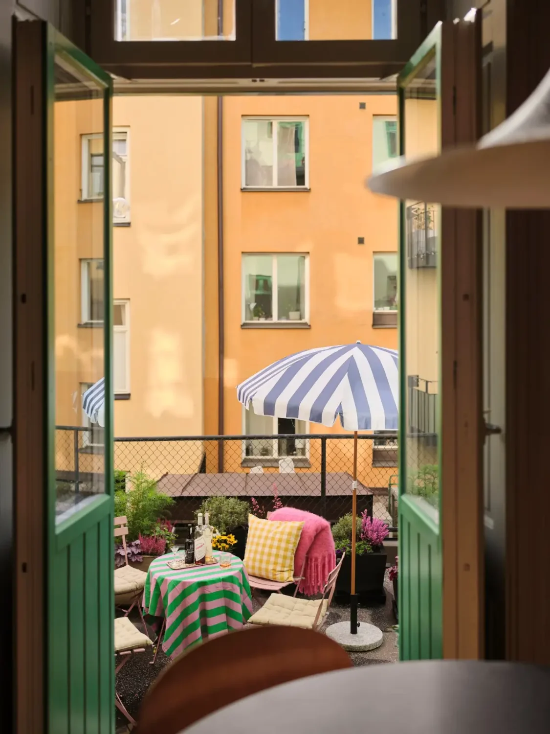 Color, Books, and a Walk-In Wardrobe in a Small Stockholm Apartment 5 glass doors to terrace