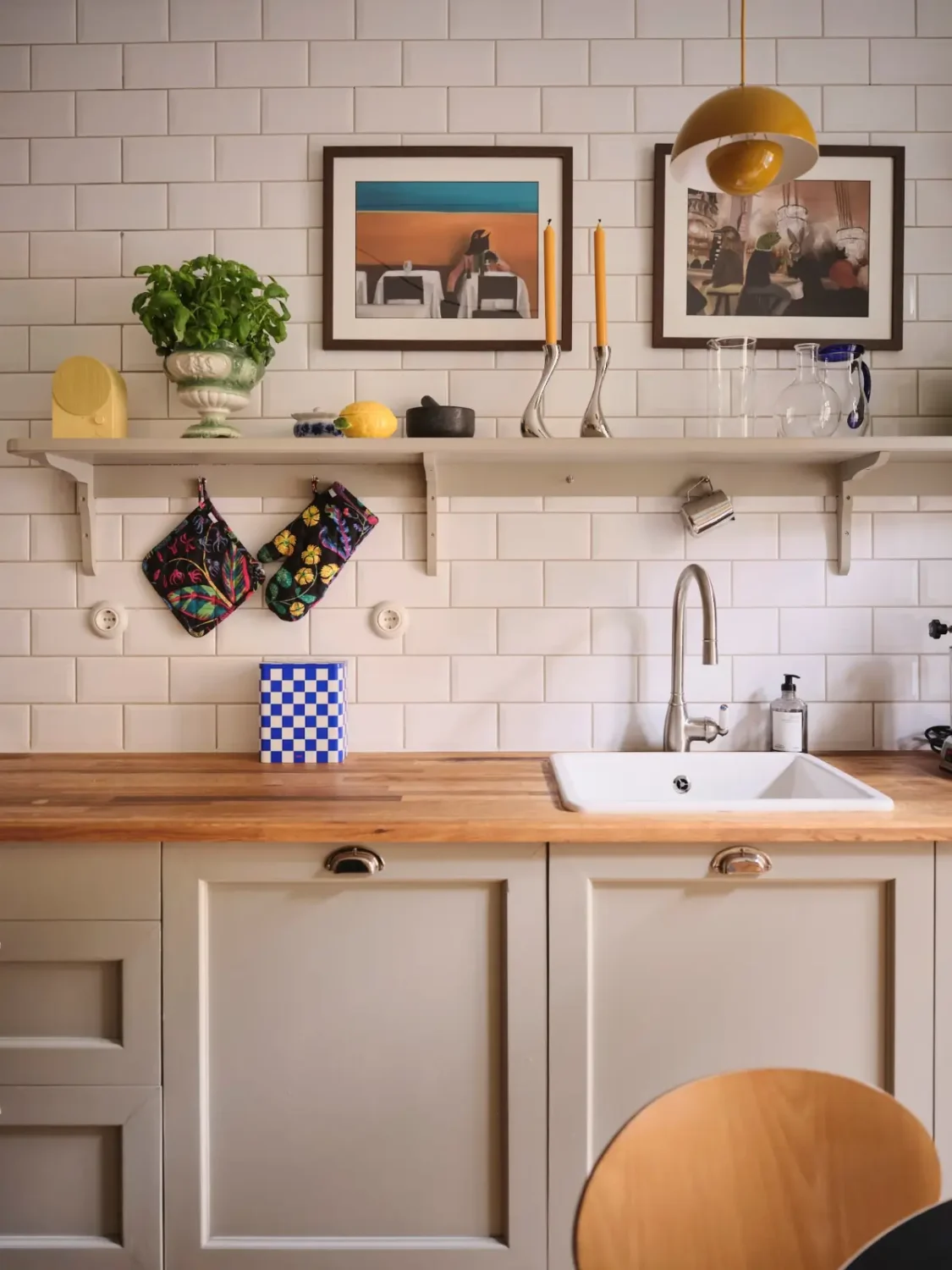 Color, Books, and a Walk-In Wardrobe in a Small Stockholm Apartment 9 gray kitchen cabinets wooden countertop white backsplash tiles nordroom