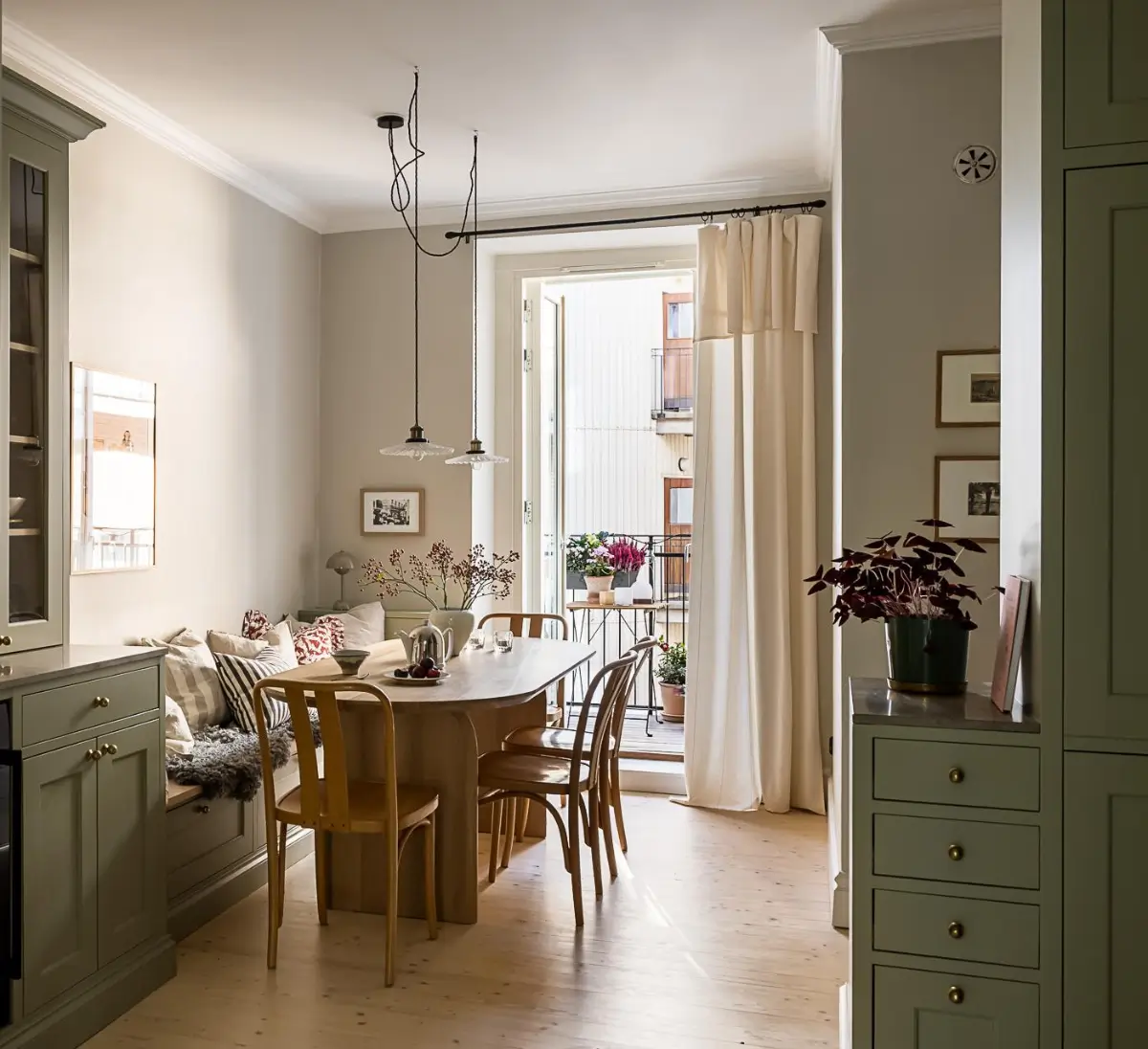 A Classic Renovated Apartment with a Social Light Green Kitchen 26 green kitchen dining table with bench A Classic Renovated Apartment with a Social Light Green Kitchen
