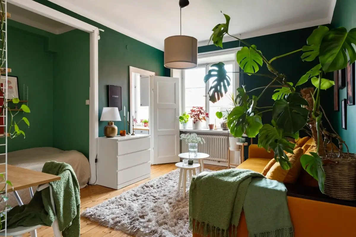 The Color Trends for 2026: A Return to Nature, Balance, and Grounding 26 green-studio-apartment-ochre-sofa-wooden-floor-nordroom