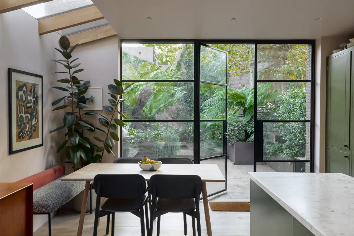 A Beautiful Victorian Townhouse Reimagined for Modern Living 18 kitchen dining table glass garden doors