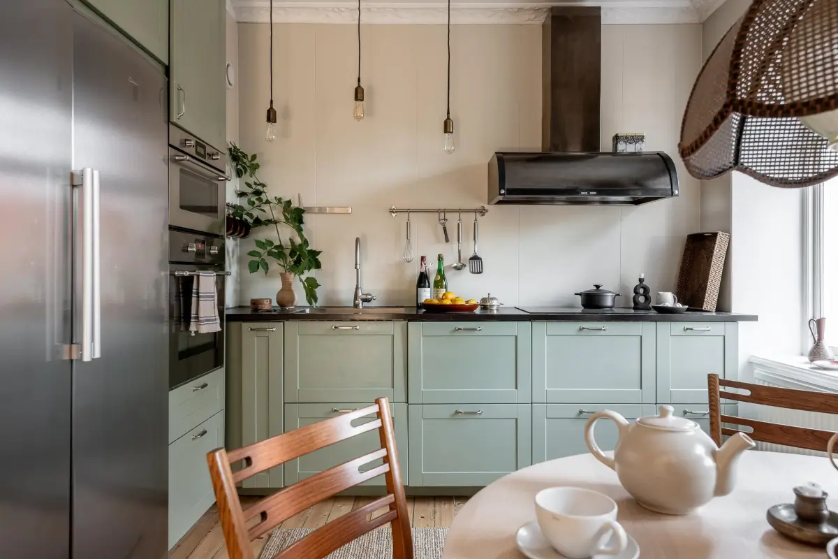 William Morris Wallpapers and Period Features in a Gothenburg Apartment 13 kitchen green cabinets round table