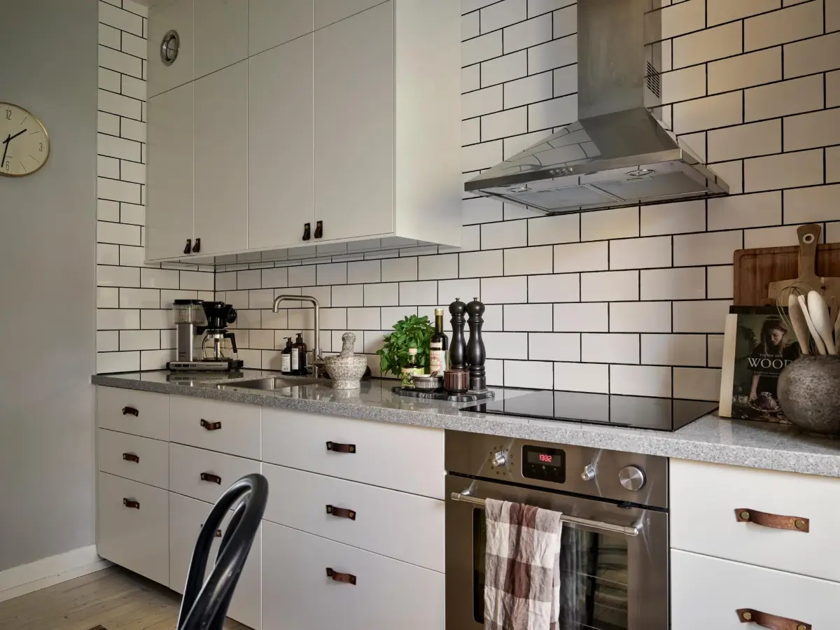 Gray Tones and High Ceilings in a Cozy Swedish Duplex Apartment 32 kitchen white backsplash tiles