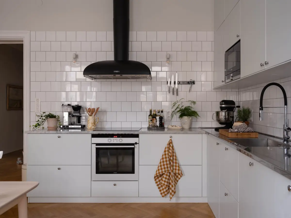 A Light and Spacious Corner Apartment in a 19th-Century Building 11 light gray kitchen marble and stainless steel countertop