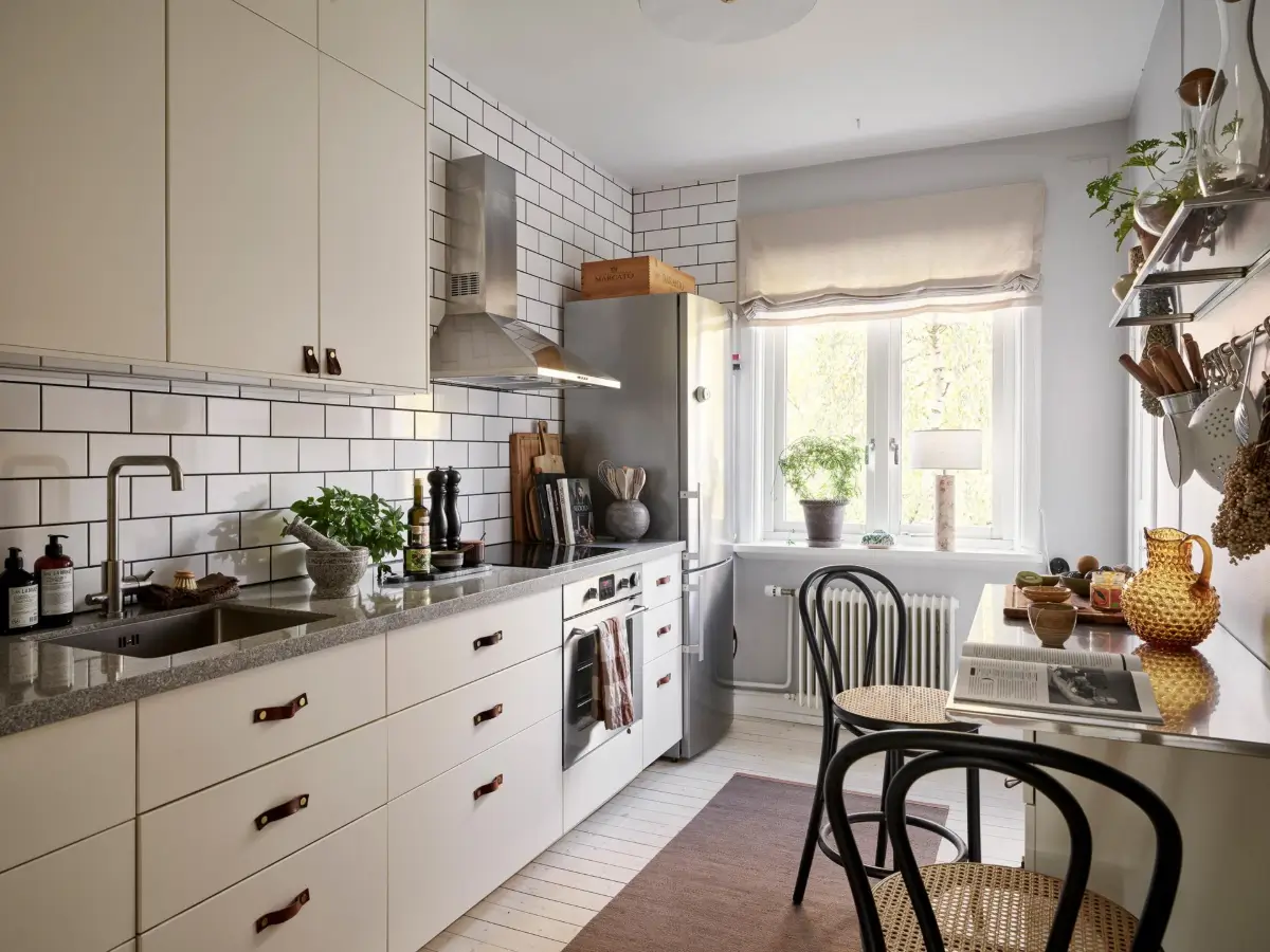 Gray Tones and High Ceilings in a Cozy Swedish Duplex Apartment 28 light kitchen wooden floor white backsplash tiles