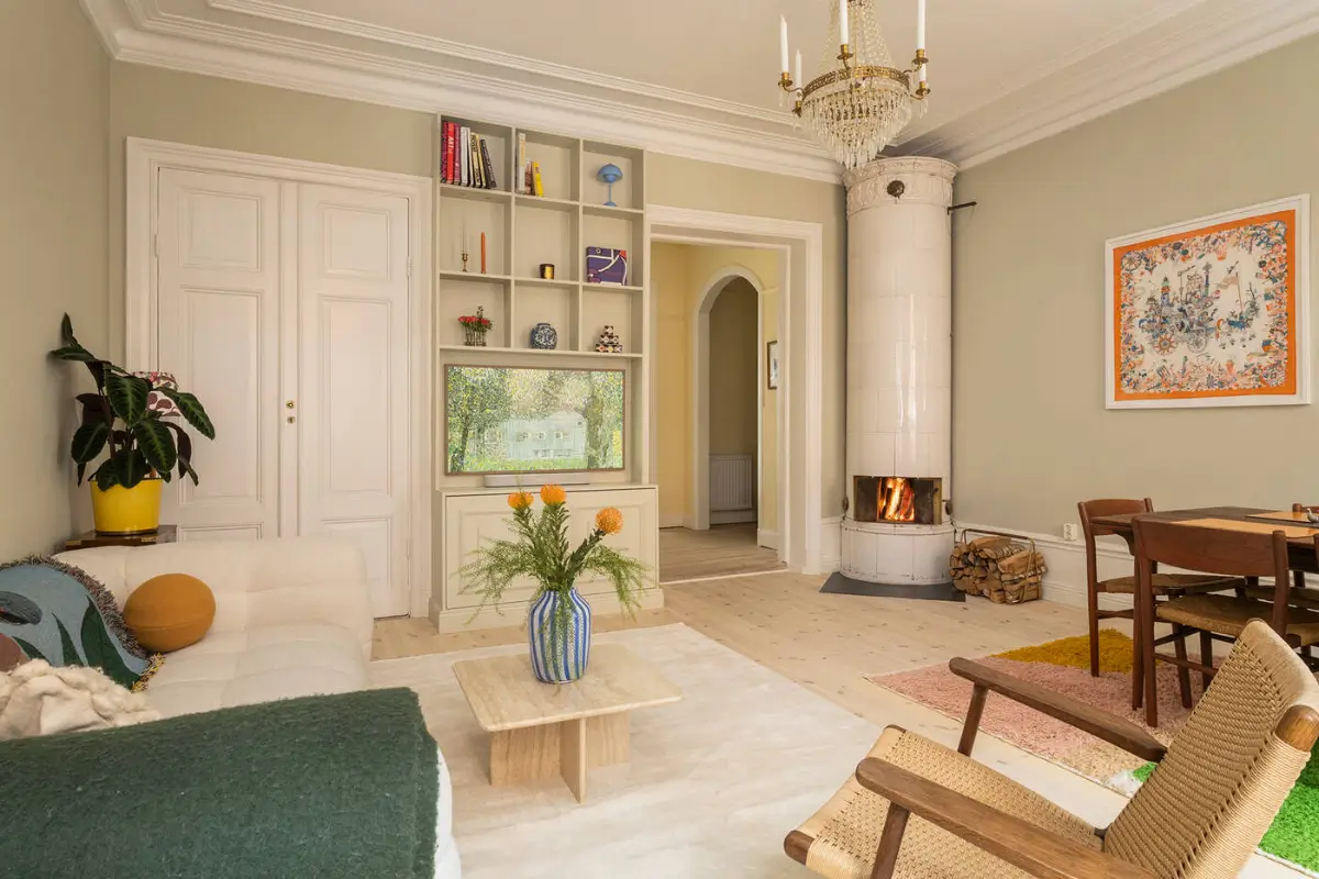 A Stylish Beige Apartment with a Light Blue Kitchen 3 living room beige walls built-in television cabinet fireplace