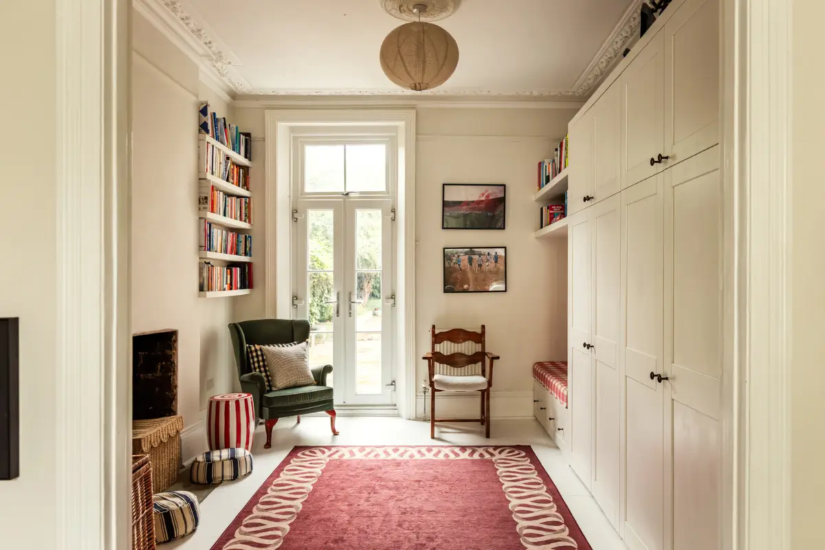 Period Elements and Subtle Color Accents in a Victorian Family Home 6 living room bookshelves built-in closets bench