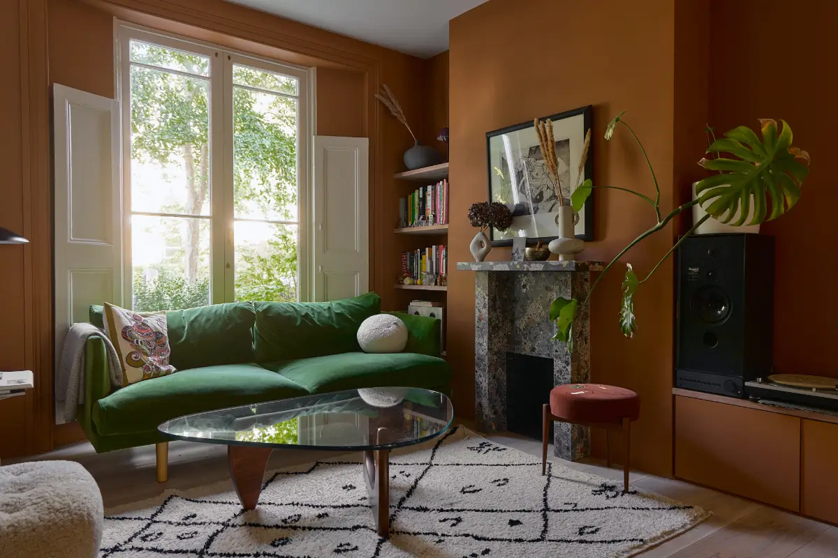 A Beautiful Victorian Townhouse Reimagined for Modern Living 3 living room green sofa terracotta brown walls nordroom