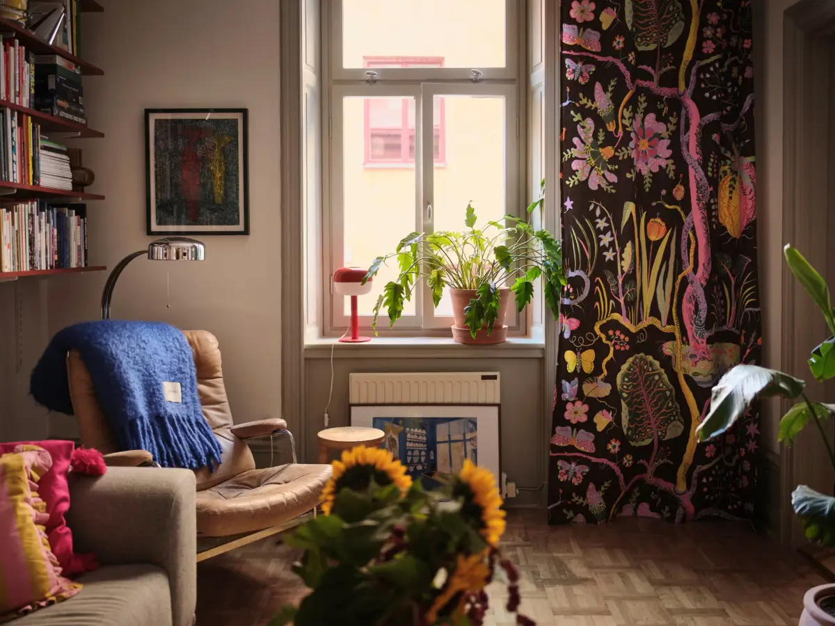 Color, Books, and a Walk-In Wardrobe in a Small Stockholm Apartment 14 living room josef frank patterned curtain