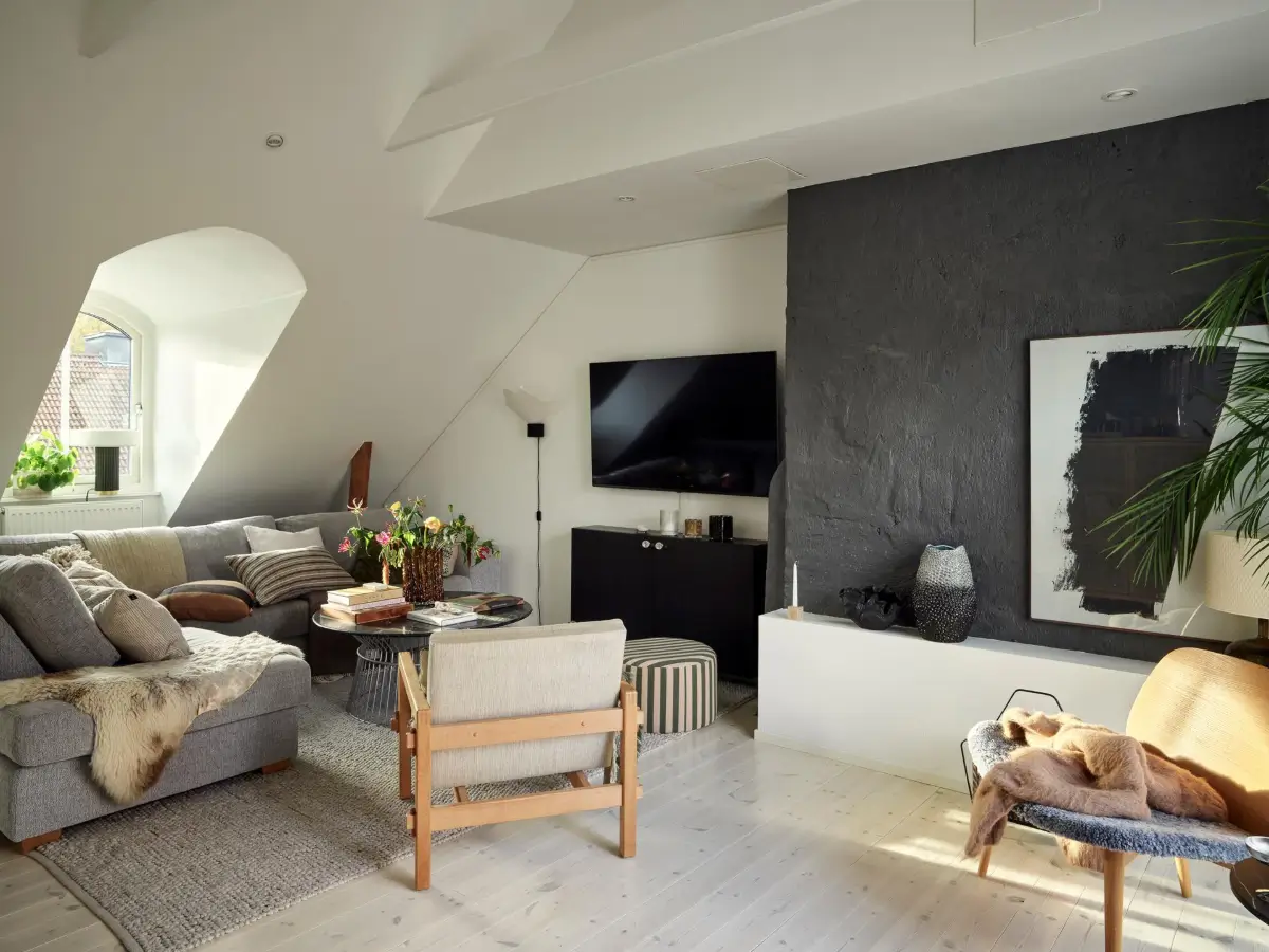 Gray Tones and High Ceilings in a Cozy Swedish Duplex Apartment 2 living room pitched ceiling dark gray accent wall