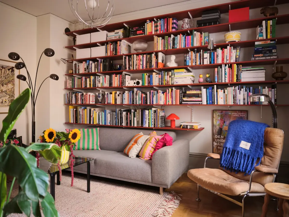Color, Books, and a Walk-In Wardrobe in a Small Stockholm Apartment 13 living room red bookshelves nordroom