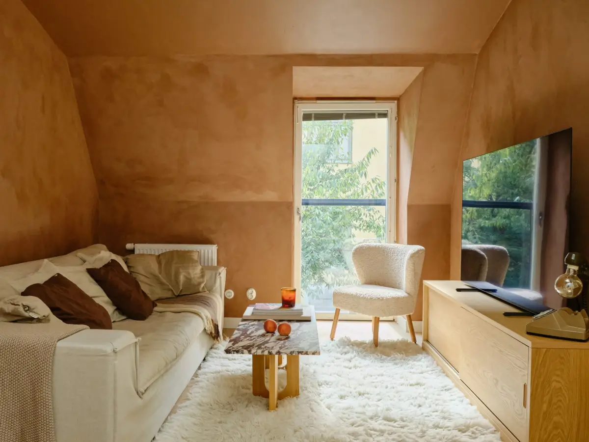 Former Stables Transformed into a Modern, Light House with Plaster Walls 11 living room terracotta colored plaster walls