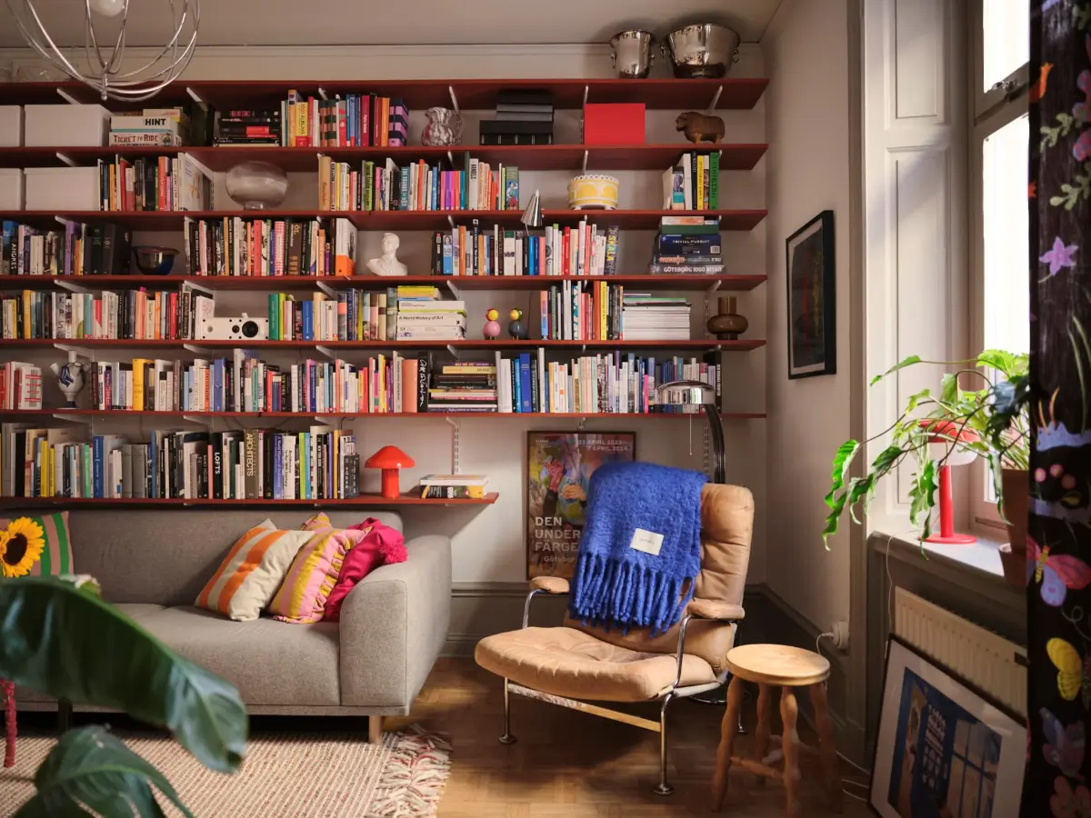 Color, Books, and a Walk-In Wardrobe in a Small Stockholm Apartment 15 living room wall of red painted wooden bookshelves nordroom