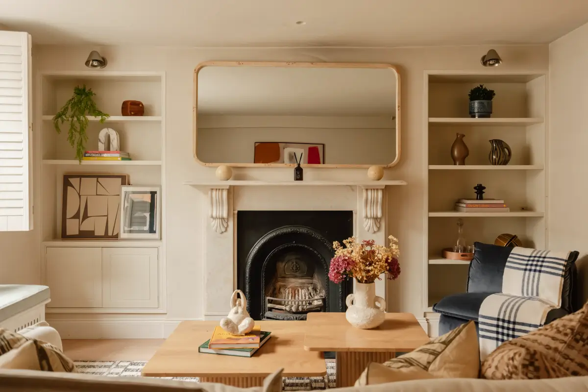 living room with fireplace flanked by built-in shelves