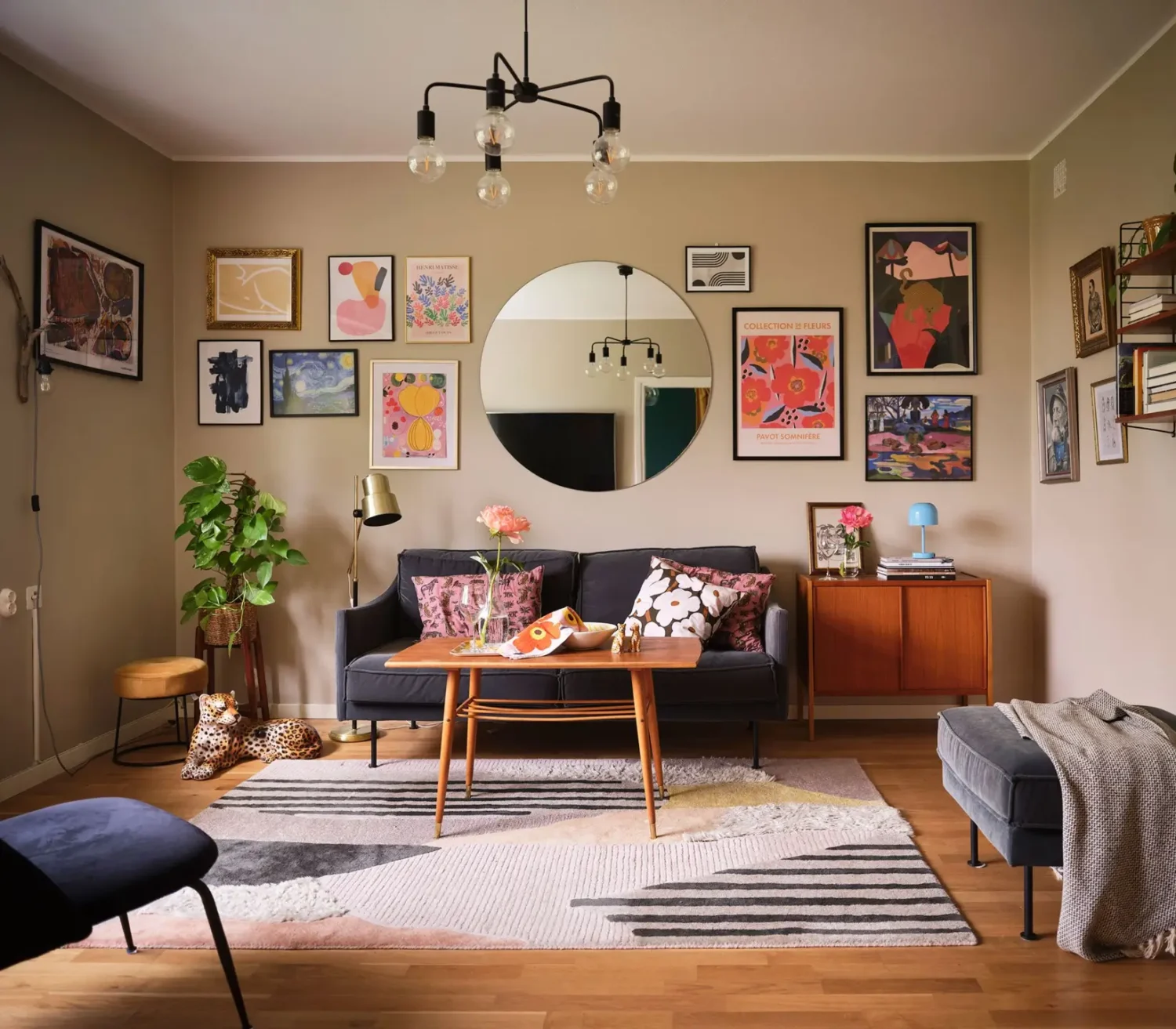A Natural Color Palette in a Swedish 1940s Apartment 1 living room with round mirror and gallery wall