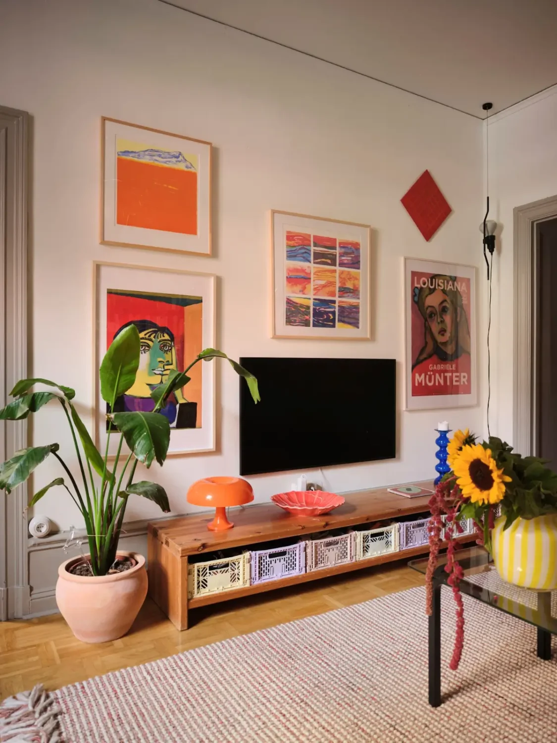 Color, Books, and a Walk-In Wardrobe in a Small Stockholm Apartment 16 low wooden cabinet television surrounded by art