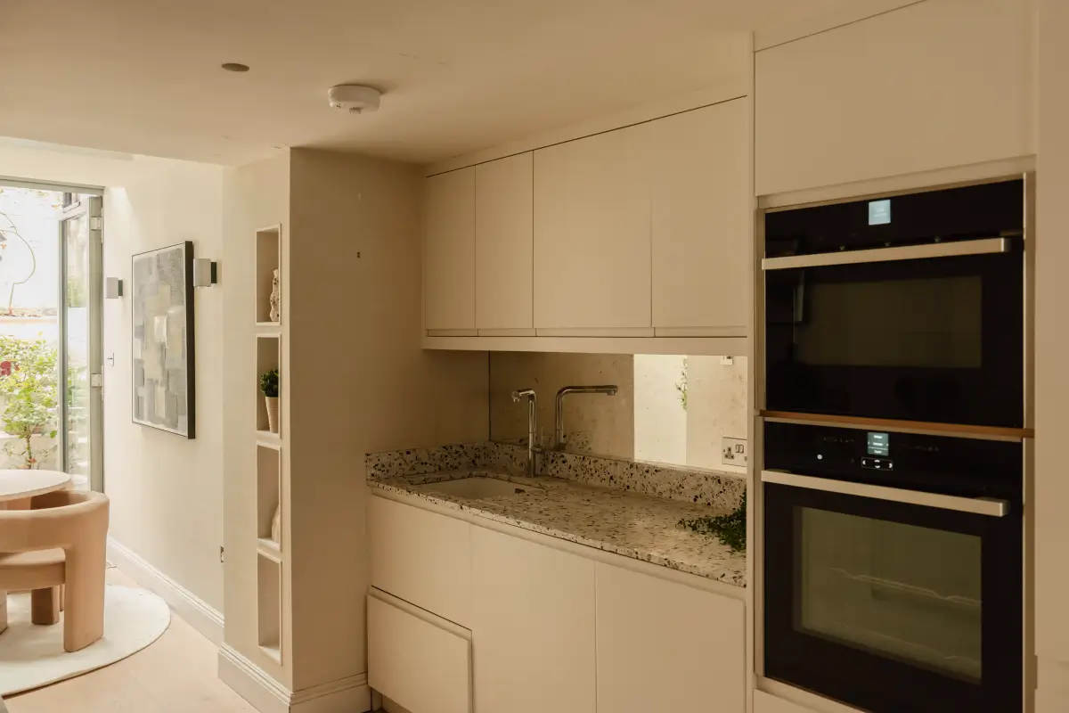 A Serene Duplex Apartment with a Glass Extension in London 9 modern white kitchen terrazzo countertop
