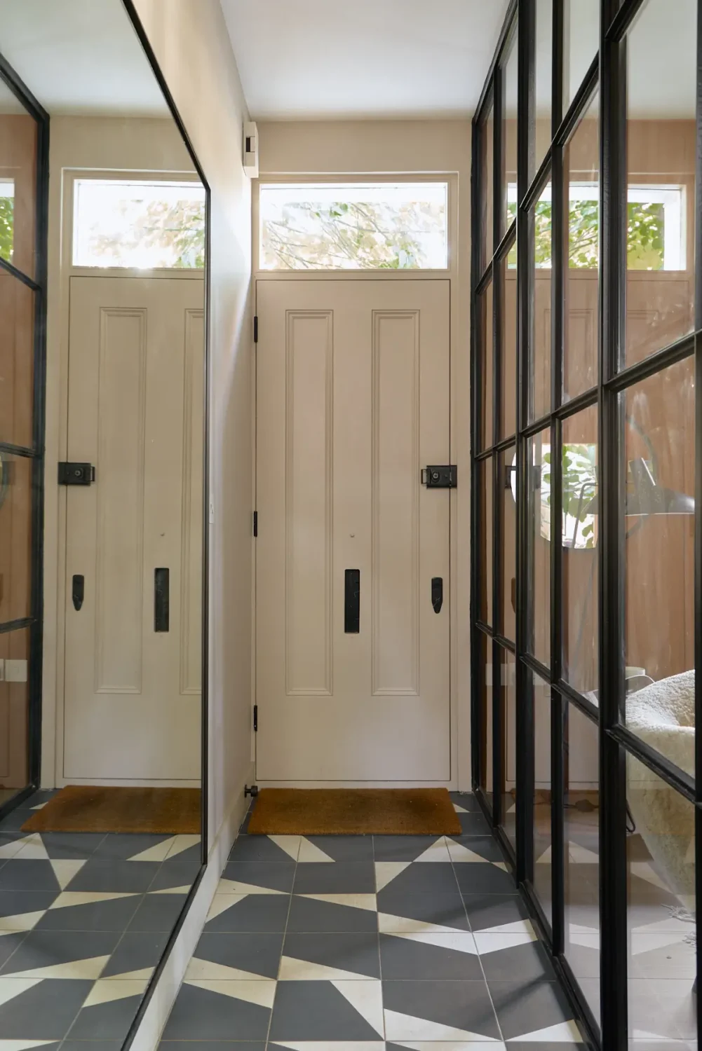 A Beautiful Victorian Townhouse Reimagined for Modern Living 26 narrow hall large mirror geometric floor tiles nordroom