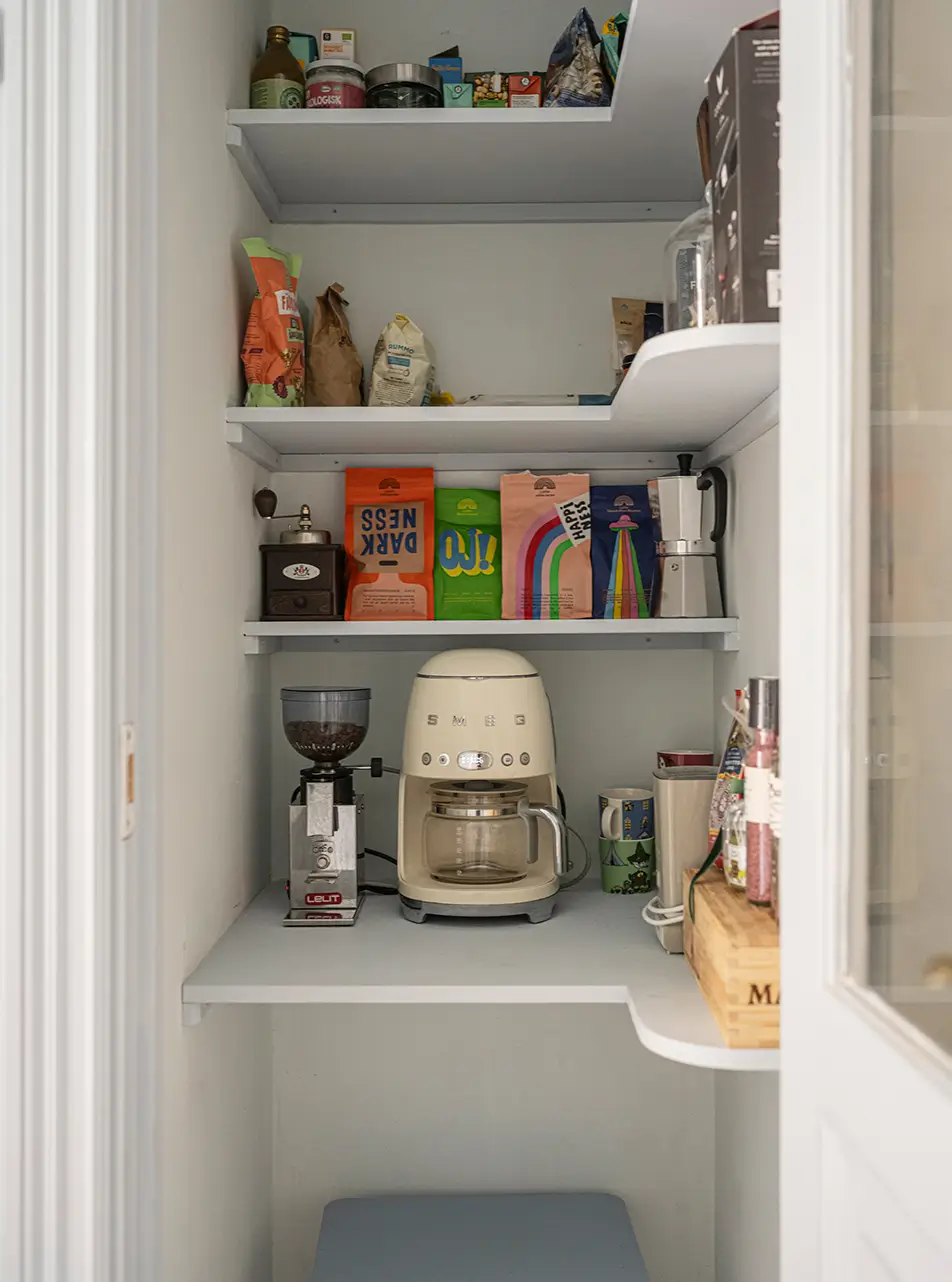 A Stylish Beige Apartment with a Light Blue Kitchen 20 pantry shelves