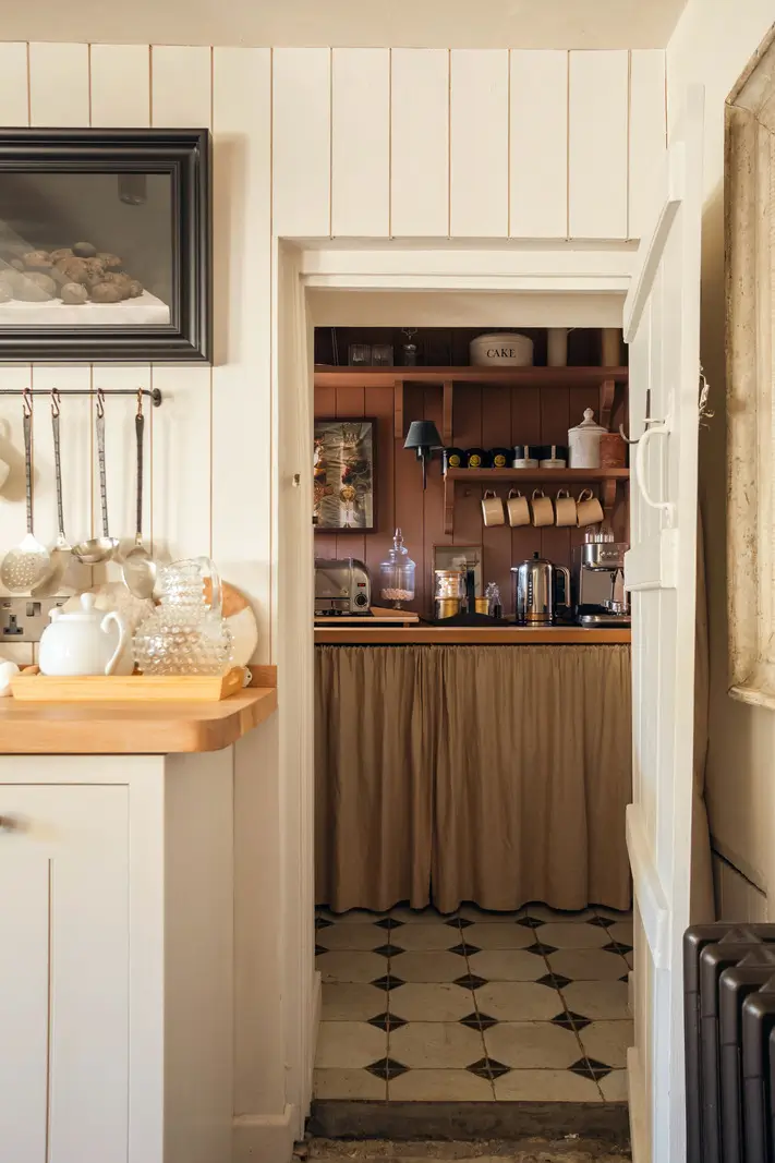 Lime Paint and Cozy Rooms in a Charming English Cottage 5 peek into pink utility space with paneling nordroom
