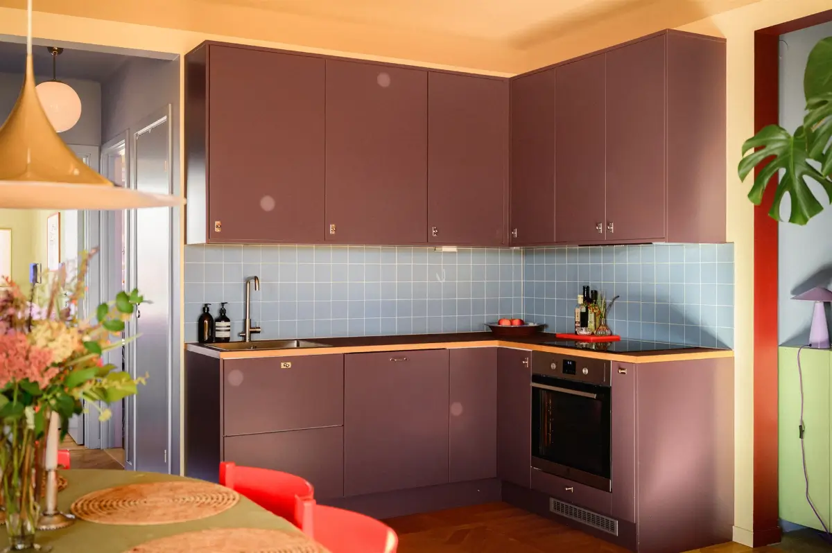 A Colorful Stockholm Family Apartment with Views of the Lake 13 plum colored kitchen blue tiles
