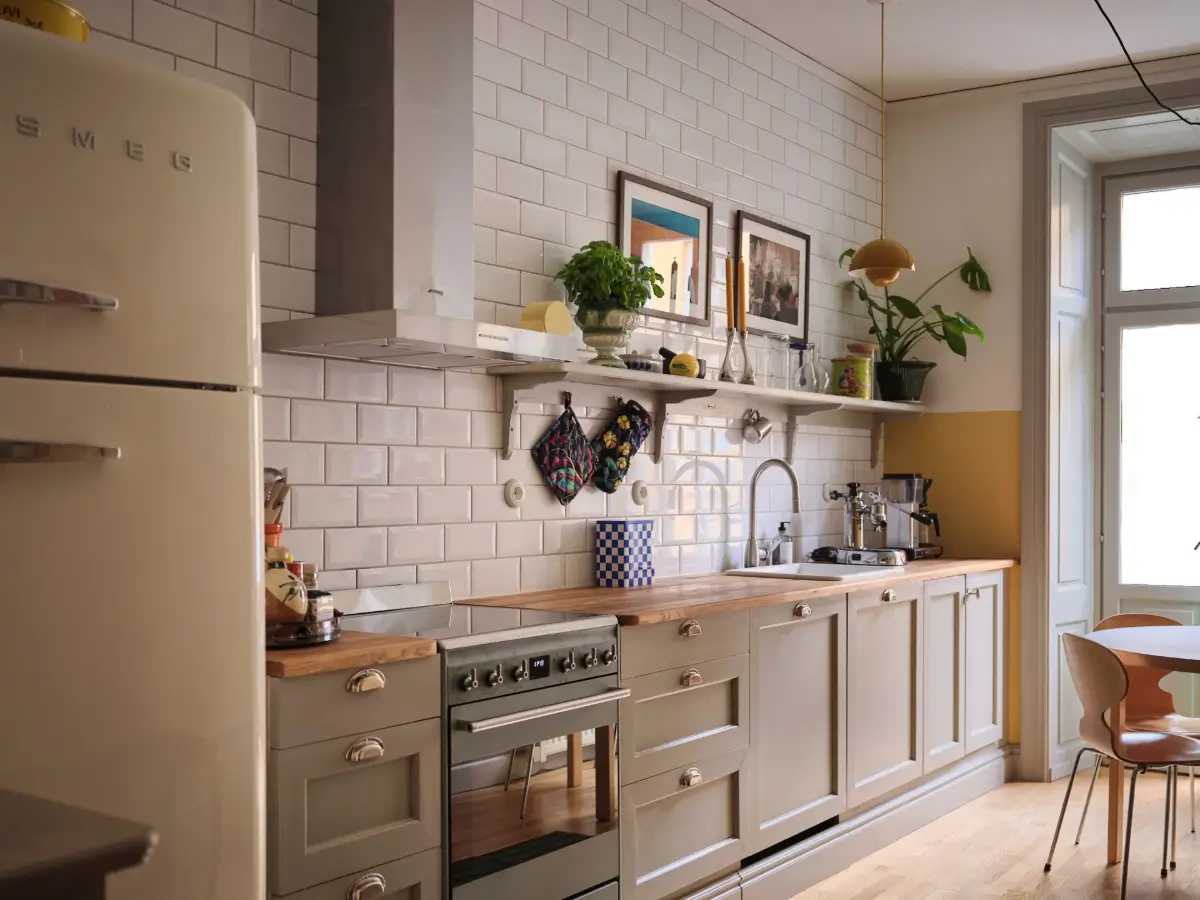 Color, Books, and a Walk-In Wardrobe in a Small Stockholm Apartment 2 rustic-gray-kitchen-cabinets-white-backsplash-tiles-nordroom